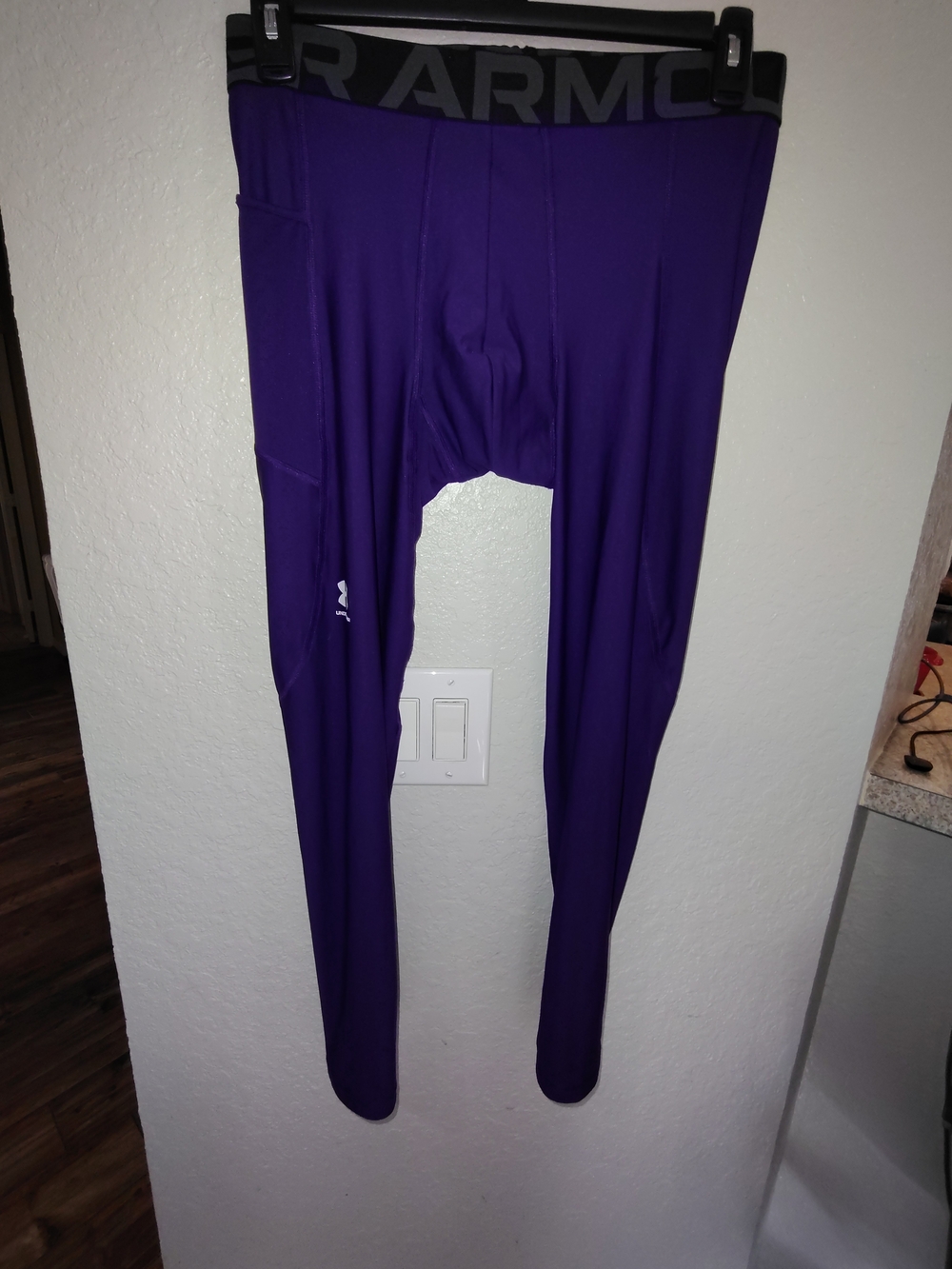 A pair of Under Armour HeagGear Men's XL Compression Leggings in purple. L-23